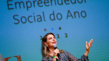Priscila Cruz é Mulher Loira em pé em cima do palco do Prêmio Empreendedor Social 2022