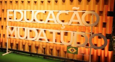 letra caixa escrito Educação Muda Tudo junto à logomarca Todos Pela Educação